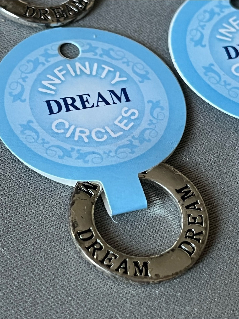 NWT eleven infinity circle imprinted with dream.  Layered in sterling silver.